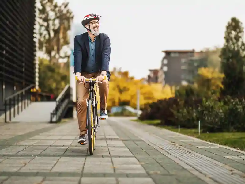 Man with a helmet riding a bicycle.