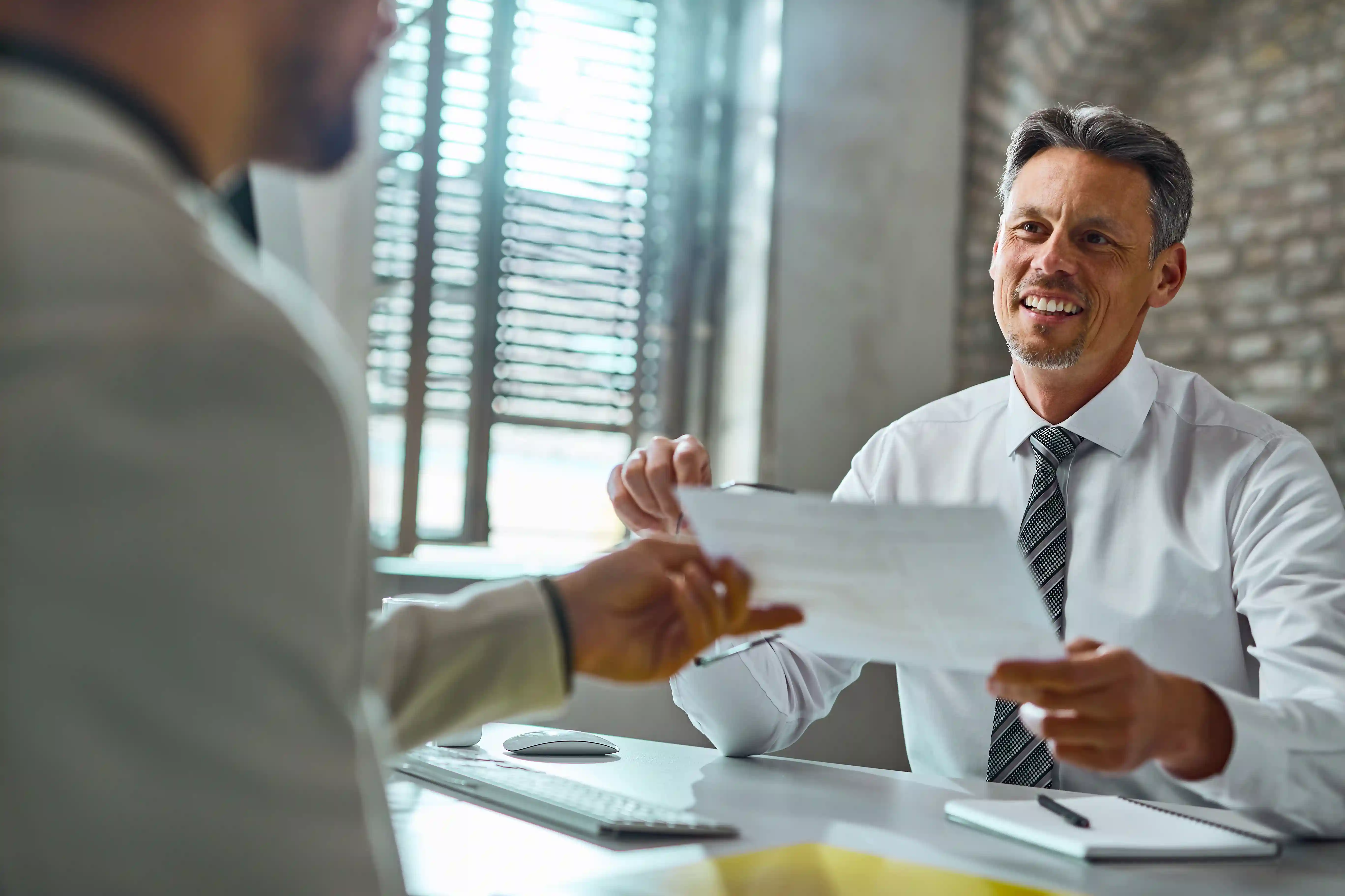 Two businessmen reviewing a contract.