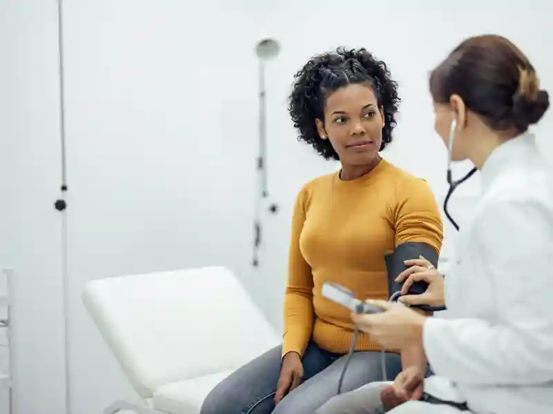 A doctor taking a patient's blood pressure.